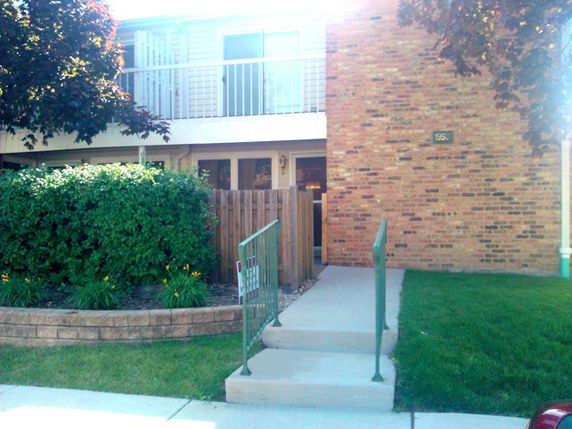 Front view of a two-story brick building with a balcony.