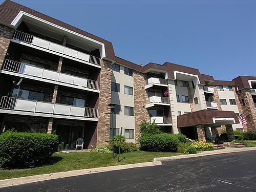 Front view of a multi-story residential building with balconies.