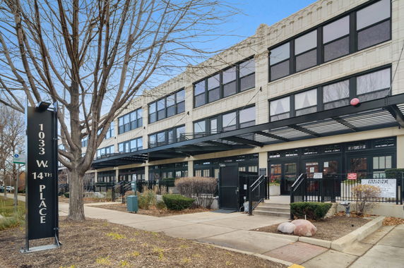 Front view of a multi-story building with large windows at 1033 W 14th Place.