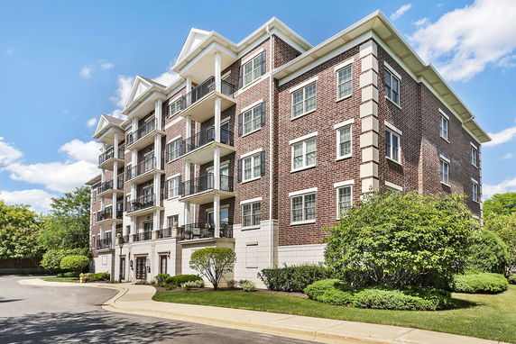 Front view of a multi-story brick building with balconies.