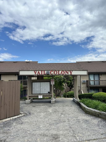 Front view of a residential building with signage reading 'Vail Colony'.