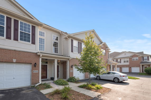 Front view of a two-story townhome with brick and siding exterior.