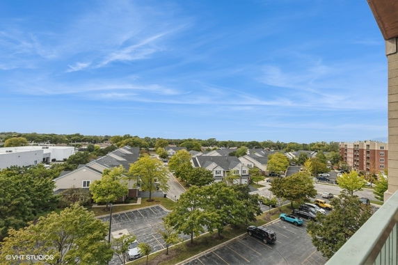 Panoramic view of a residential area with houses and parking lots.
