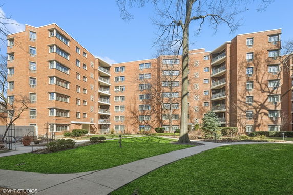 Front view of a multi-story brick apartment building.