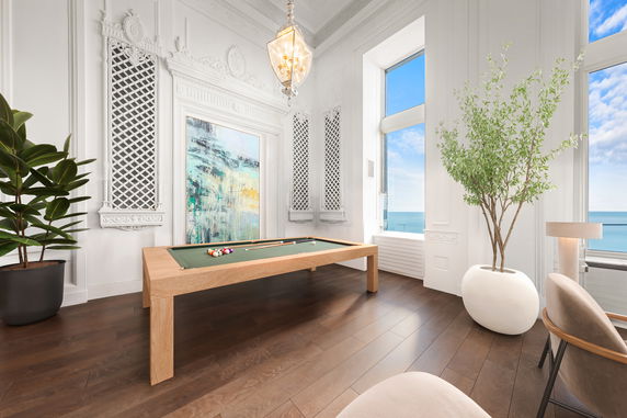 Interior view of a room with a pool table and decorative elements.