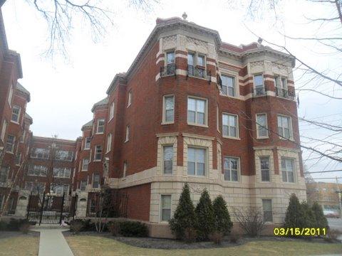 Front view of a multi-story brick apartment building.