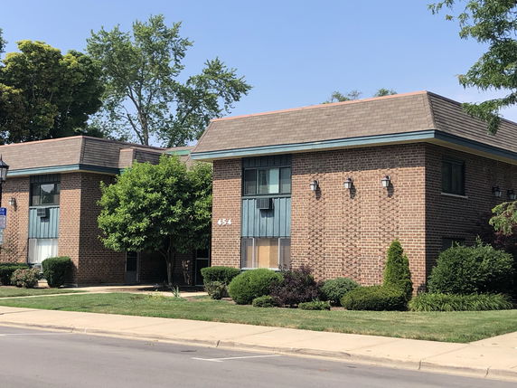 Front view of a two-story brick building with a flat roof.