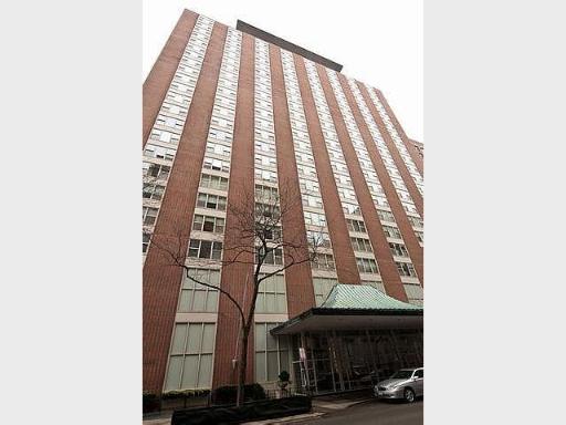 Front view of a tall high-rise building with multiple windows.
