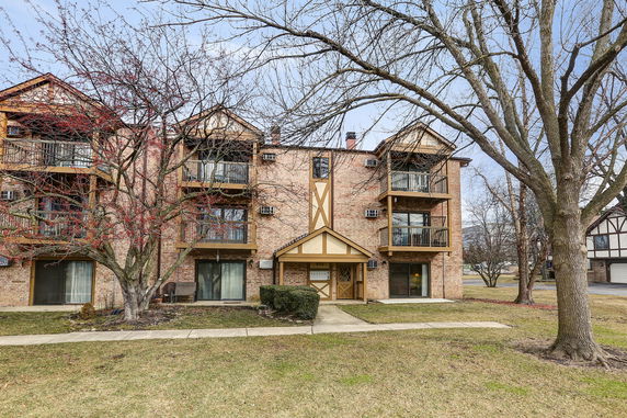 Front view of a multi-story building with balconies.