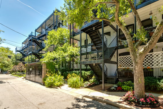 Front view of a multi-story building with exterior stairs and balconies.