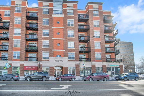 Front view of a multi-story residential building with balconies.