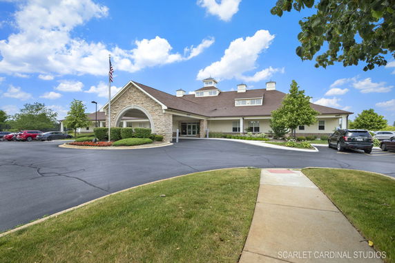 Front view of a single-story building with a gabled roof and stone accents.