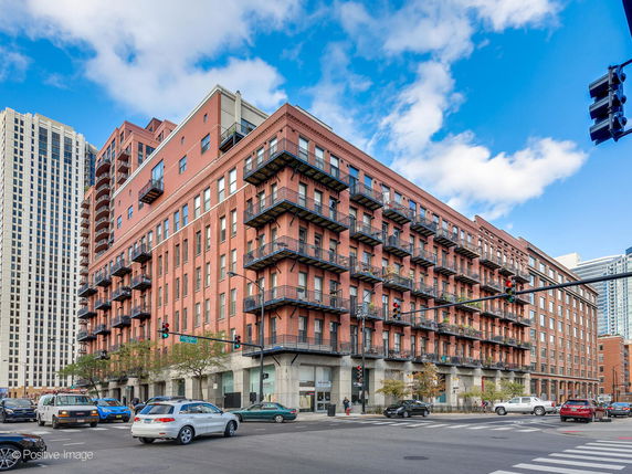 Front view of a multi-story brick building with balconies.