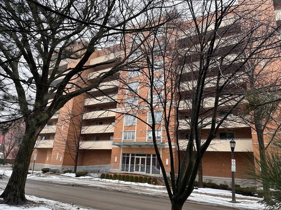 Front view of a multi-story residential building with balconies.