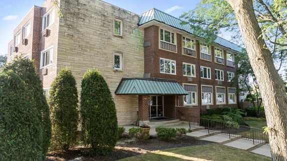 Front view of a multi-story building with brick and stone facade.