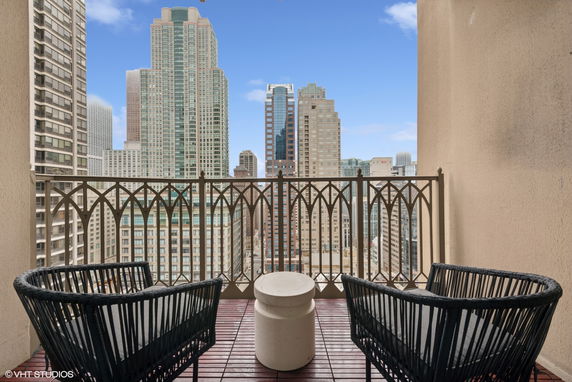 View from a balcony showing a city skyline with tall buildings.