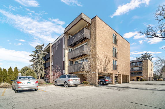 Front view of a multi-story apartment building with balconies.