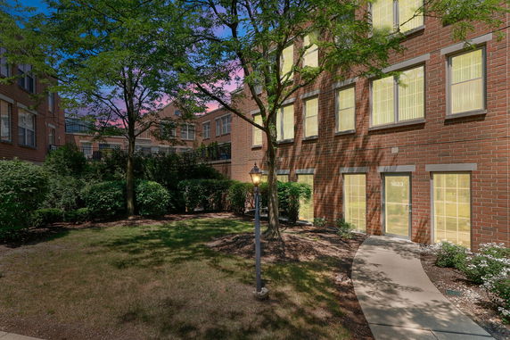Front view of a brick building with multiple windows.
