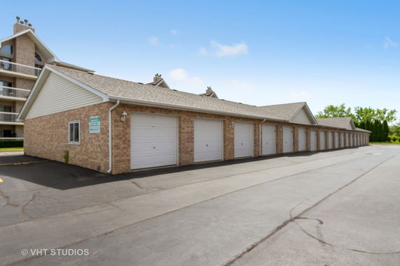 Row of garage doors in an outdoor parking area.