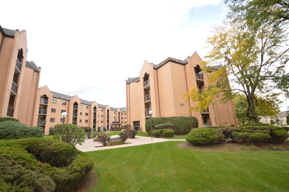 Front view of multiple multi-story apartment buildings.