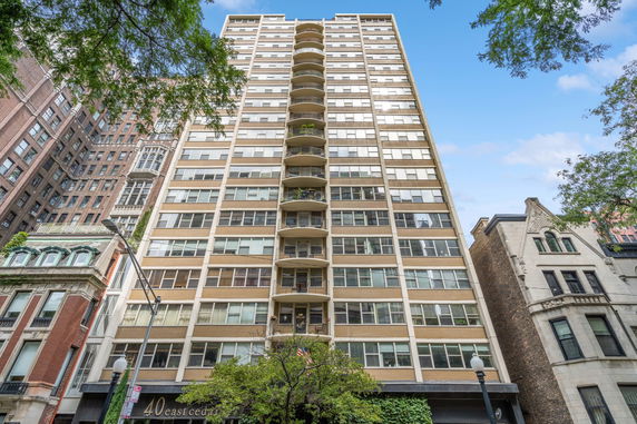 Front view of a multi-story apartment building with balconies.