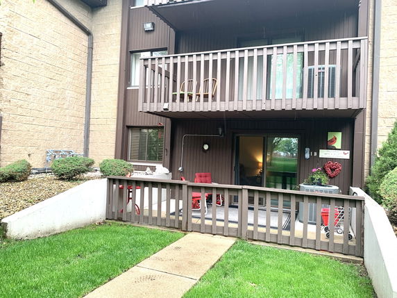 Front view of a multi-story residential building with balconies.