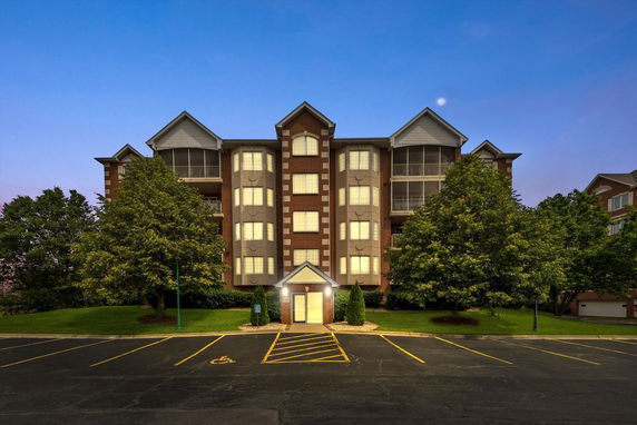 Front view of a multi-story building with a central entrance.