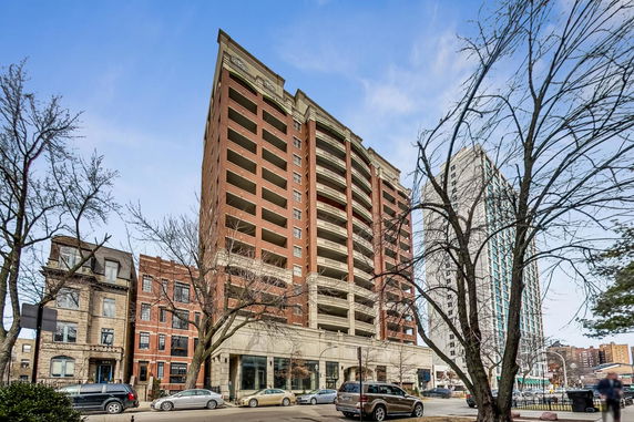 Front view of a multi-story residential building with balconies.