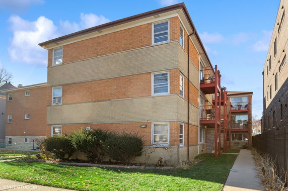Front view of a three-story brick apartment building.