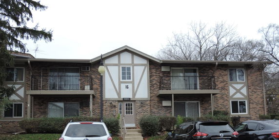 Front view of a two-story apartment building with brick exterior.