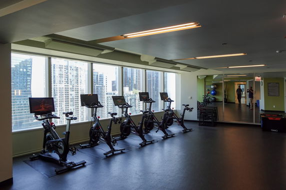 Indoor gym area with exercise bikes and large mirrors.
