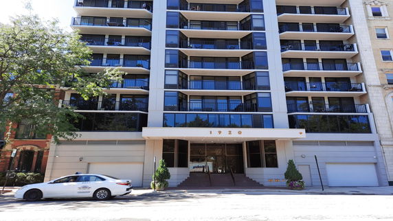 Front view of a multi-story residential building with balconies.