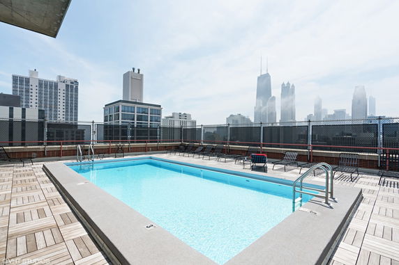Rooftop swimming pool with surrounding city skyline.