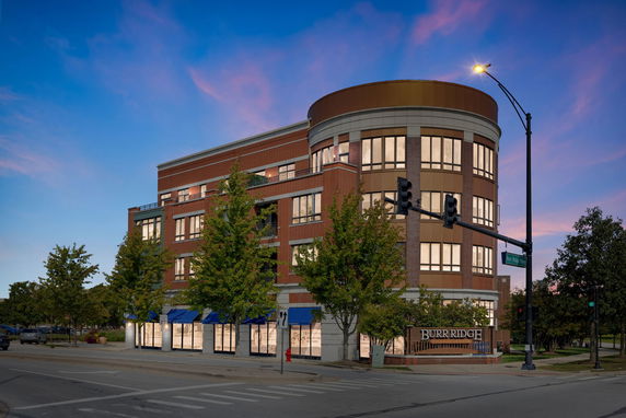 Front view of a multi-story commercial building at dusk.