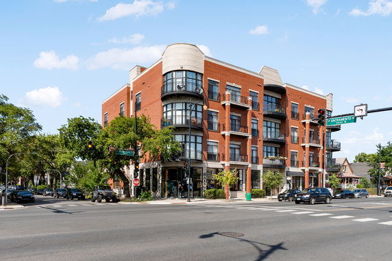 Front view of a multi-story brick building at an intersection.