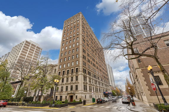 Front view of a multi-story brick building on a city street.