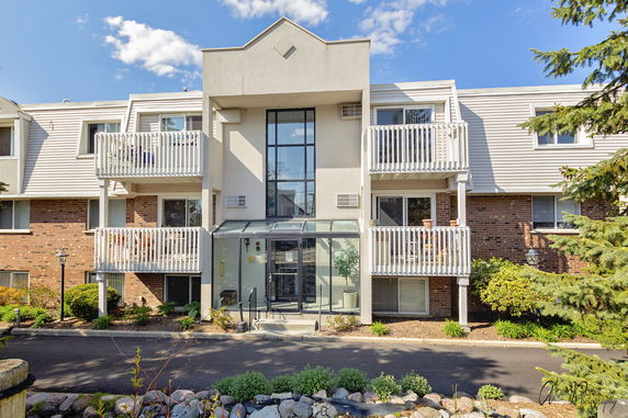 Front view of a multi-story residential building with balconies.