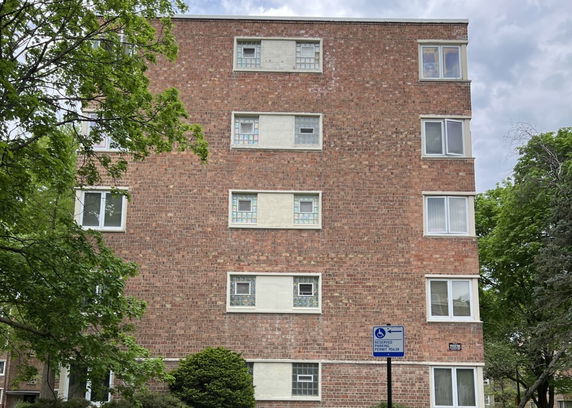 Front view of a multi-story brick building.