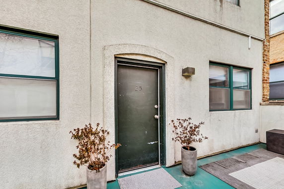 Front view of a building entrance with a door labeled 25