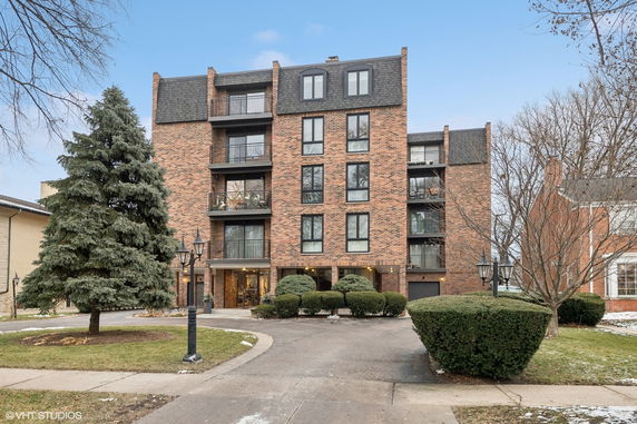 Front view of a multi-story brick apartment building.