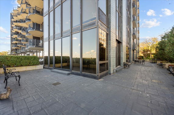 Front view of a multi-story building with large windows and balconies.