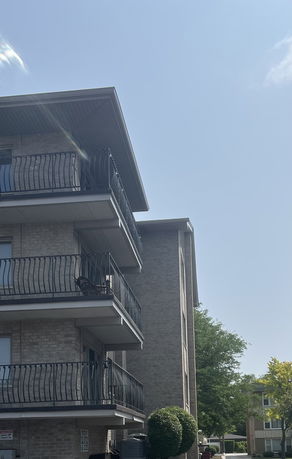 Side view of a multi-story building with balconies.