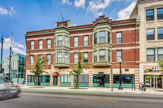Front view of a multi-story building with decorative elements.