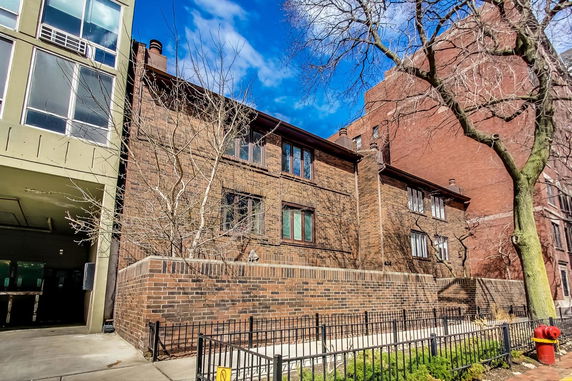 Front view of a brick two-story building with multiple windows.