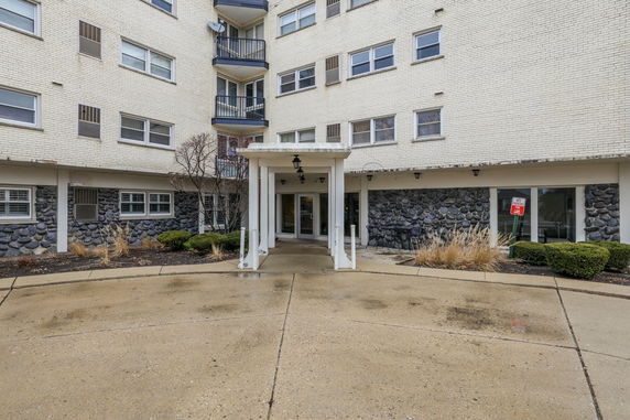 Front view of a multi-story building with a covered entrance.