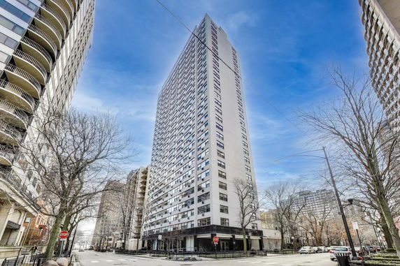 Front view of a tall high-rise building in an urban environment.
