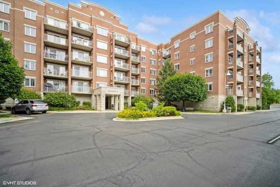 Front view of a multi-story brick apartment building.