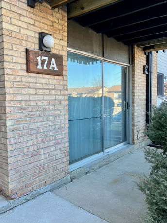 Exterior view of a brick building labeled 17A with a large glass sliding door.