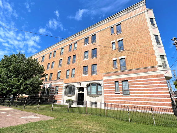 Front view of a multi-story brick building.