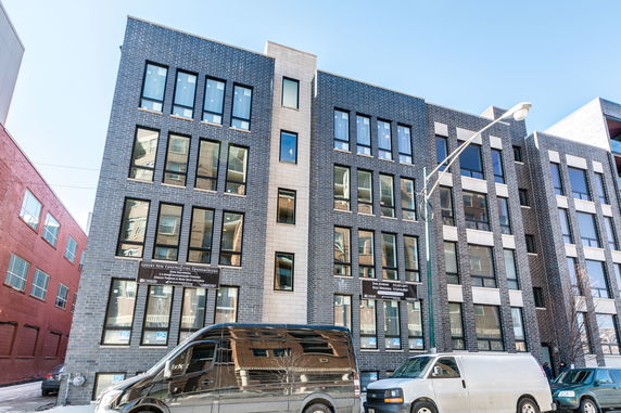 Front view of a multi-story condominium building with a modern facade.